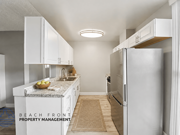 Alhambra apartment for rent - A kitchen with white cabinets and a granite countertop.