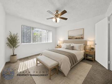 Redondo Beach apartment for rent - A bedroom with a bed, a bench, and a ceiling fan.