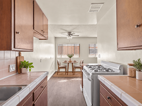 Inglewood apartment for rent - A kitchen with a stove, sink, and dining table.