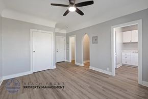 Los Angeles apartment for rent - A spacious room with a ceiling fan and wooden flooring.