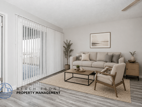 Norwalk apartment for rent - A living room with a couch, chair, and a plant.