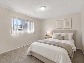 Inglewood apartment for rent - A bedroom with a large bed and two picture frames on the wall.
