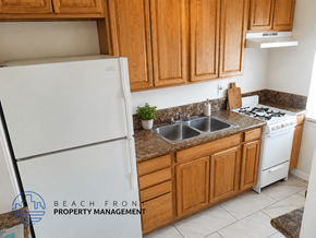 Pasadena apartment for rent - A kitchen with wooden cabinets and a white refrigerator.
