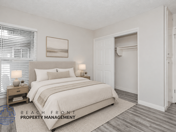 Norwalk apartment for rent - A well-lit bedroom with a large bed and a painting on the wall.