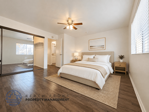 Hawthorne apartment for rent - A bedroom with a bed, nightstand, and a ceiling fan.