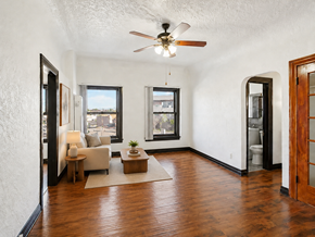 Torrance apartment for rent - A living room with a ceiling fan and hardwood floors.