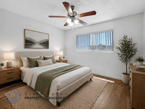 Long Beach apartment for rent - A bedroom with a bed, nightstands, a ceiling fan, and a painting on the wall.