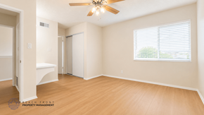 La Habra apartment for rent - A spacious room with a ceiling fan and a window with blinds.
