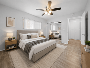 Long Beach apartment for rent - A bedroom with a large bed and a ceiling fan.