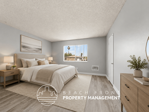 Inglewood townhouse for rent - A bedroom with a large bed and a view of the beach through the window.