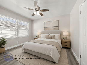 Santa Ana apartment for rent - A well-lit bedroom with a large bed and a ceiling fan.