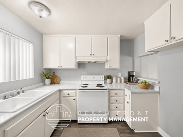 Inglewood townhouse for rent - A kitchen with white cabinets and a stove top oven.