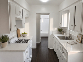 Norwalk apartment for rent - A white kitchen with a stove, sink, and cabinets.