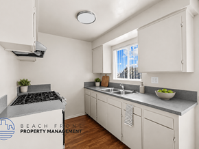Hawthorne apartment for rent - A kitchen with white cabinets and a stove top oven.