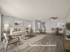 Inglewood townhouse for rent - A living room with a staircase in the background and a logo for Beach Front Property Management.