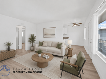 Long Beach apartment for rent - A living room with a white couch, a coffee table, and a painting on the wall.