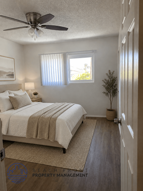 Buena Park apartment for rent - A bedroom with a bed, a ceiling fan, and a window with blinds.