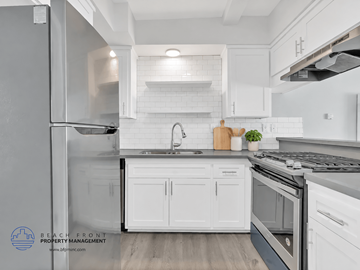 Redondo Beach apartment for rent - A modern kitchen with white cabinets and stainless steel appliances.