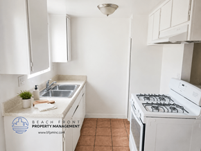 Harbor City apartment for rent - A kitchen with a stove, sink, and cabinets.