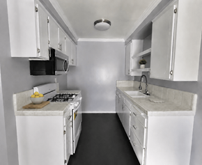 Hawthorne apartment for rent - A small white kitchen with a microwave, oven, and sink.