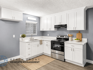 Santa Ana apartment for rent - A kitchen with white cabinets and a stainless steel stove.