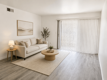 Huntington Beach apartment for rent - A living room with a couch, a small table, and a painting on the wall.