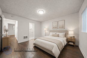 Redondo Beach apartment for rent - A bedroom with a large bed and a nightstand with a lamp.