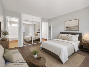 Carson apartment for rent - A bedroom with a large bed, a couch, and a coffee table.