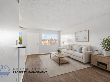Hawthorne apartment for rent - A living room with a couch, coffee table, and a painting on the wall.