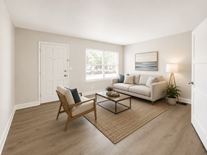 Long Beach apartment for rent - A living room with a white couch, a wooden chair, and a coffee table.