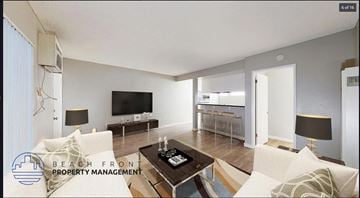 Downey apartment for rent - A living room with a white couch and a television.