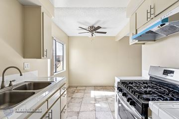 Hawthorne apartment for rent - A kitchen with a stove top oven and a sink.