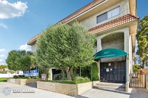 Hawthorne apartment for rent - A building with a green awning and the words "4111 Beachfront Apartments" written on it.