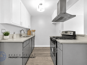 Long Beach apartment for rent - A kitchen with a stove top oven and a range hood.