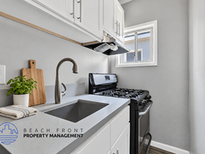 Long Beach apartment for rent - A kitchen with a stove, sink, and a window.