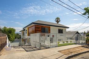 Los Angeles apartment for rent - a small house with a fence and a palm tree