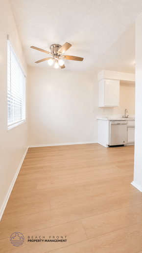 La Habra apartment for rent - A room with a ceiling fan and wooden flooring.