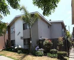 Long Beach apartment for rent - a white house with a yard and a fence