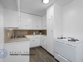 Inglewood apartment for rent - A kitchen with white cabinets and a stove top oven.