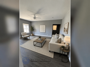 Los Angeles apartment for rent - A living room with a white couch, a coffee table, and a ceiling fan.