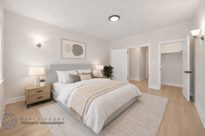 Los Angeles apartment for rent - A well-lit bedroom with a large bed and a nightstand with a lamp.