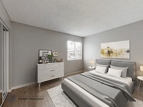 Paramount apartment for rent - A well-lit bedroom with a large bed and a nightstand with a lamp.