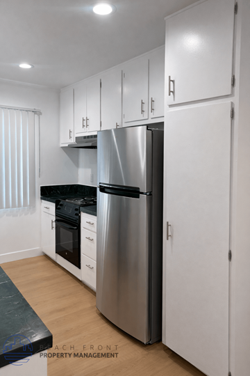 Long Beach apartment for rent - A modern kitchen with a stainless steel refrigerator and white cabinets.