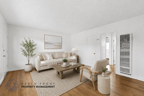 Hawthorne apartment for rent - A living room with a couch, chair, and a potted plant.