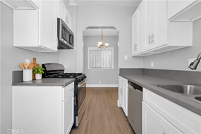 Long Beach apartment for rent - A kitchen with white cabinets and a black stove top.