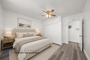 Inglewood apartment for rent - A bedroom with a bed, nightstand, and a ceiling fan.