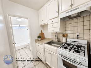 Los Angeles apartment for rent - A kitchen with a stove, sink, and cabinets.