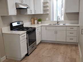 Lomita apartment for rent - A kitchen with white appliances and cabinets.