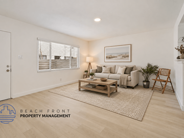 Buena Park apartment for rent - A living room with a couch, a coffee table, and a painting on the wall.