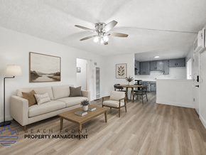 La Habra apartment for rent - A living room with a couch, a coffee table, and a ceiling fan.